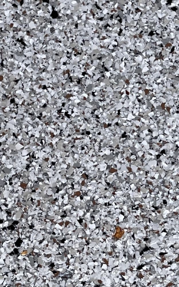 Close-up of a durable gray and white quartz broadcast floor coating texture